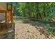 Spacious fenced backyard with mature trees and access to a wooden deck with stairs at 202 Cedar Valley Ct, Canton, GA 30115