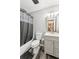 This bathroom has a modern vanity and tub shower with stylish gray finishes at 202 Cedar Valley Ct, Canton, GA 30115