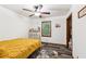 This bedroom features a ceiling fan, a large window, and modern flooring at 202 Cedar Valley Ct, Canton, GA 30115