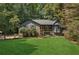Charming home with covered front porch, well-manicured lawn, and beautiful mature landscaping at 202 Cedar Valley Ct, Canton, GA 30115