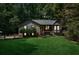 Charming home featuring a lush green lawn and inviting screened in front porch perfect for relaxing outdoors at 202 Cedar Valley Ct, Canton, GA 30115