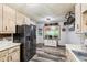 Well-equipped kitchen featuring modern appliances, wood-look flooring, and ample counter space, designed for culinary enthusiasts at 202 Cedar Valley Ct, Canton, GA 30115