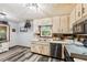 Functional kitchen with stainless steel appliances, painted cabinets, and durable flooring, ready for cooking and entertaining at 202 Cedar Valley Ct, Canton, GA 30115