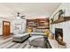 Comfortable living room with a stone fireplace, wood accent wall, and plush seating, perfect for relaxation at 202 Cedar Valley Ct, Canton, GA 30115
