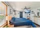 This main bedroom features a comfortable bed, ceiling fan, and a barn door to the ensuite bathroom at 202 Cedar Valley Ct, Canton, GA 30115