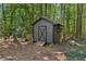 Backyard shed perfect for extra storage with wooden door at 202 Cedar Valley Ct, Canton, GA 30115