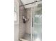 This shower features modern subway tile, glass door, and hexagon tile floor at 202 Cedar Valley Ct, Canton, GA 30115