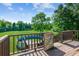 Backyard view showcasing a deck leading to an above-ground pool with lush green grass and mature trees at 60 Boardwalk Ave, Covington, GA 30016