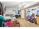 Finished basement featuring carpeted floors, a ceiling fan, and a partially visible bed at 60 Boardwalk Ave, Covington, GA 30016