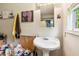 Small bathroom with a window, a vanity with a mirror, and decor at 60 Boardwalk Ave, Covington, GA 30016