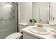 Clean and simple bathroom featuring white tiling and a glass shower enclosure at 60 Boardwalk Ave, Covington, GA 30016