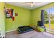 Bedroom with light green walls, carpeted floors, and a large window at 60 Boardwalk Ave, Covington, GA 30016