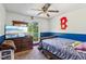 Bedroom with baseball themed decorations, carpeted floors, and a window overlooking green space at 60 Boardwalk Ave, Covington, GA 30016
