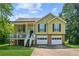 Charming two-story home with a front porch, two-car garage, and landscaped yard at 60 Boardwalk Ave, Covington, GA 30016