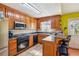 Kitchen featuring wood cabinets, granite countertops, and a breakfast bar at 60 Boardwalk Ave, Covington, GA 30016