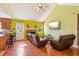 Open living room with a brick fireplace, hardwood floors, and lots of natural light at 60 Boardwalk Ave, Covington, GA 30016