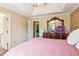 Main bedroom with an ornate wooden dresser, beige walls, and attached bathroom and closet at 60 Boardwalk Ave, Covington, GA 30016
