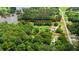 Lush wooded property with lake access, outlined in orange, with a home, and plenty of trees at 901 N Van Wert N Rd, Villa Rica, GA 30180