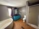 Stylish bathroom with separate shower and tub, a bright blue vanity, wood-look flooring, and a window at 901 N Van Wert N Rd, Villa Rica, GA 30180