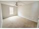 Neutral bedroom with beige carpeting, white walls, and a ceiling fan offers a blank canvas at 901 N Van Wert N Rd, Villa Rica, GA 30180