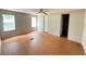 Bright bedroom featuring wood-look laminate flooring, two windows, ceiling fan, and neutral walls at 901 N Van Wert N Rd, Villa Rica, GA 30180