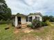 Quaint single-story home with white siding, black shutters, a small porch, and manicured landscaping at 901 N Van Wert N Rd, Villa Rica, GA 30180