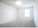 Cozy carpeted bedroom features a window, neutral walls, and ample natural light at 921 Sundown Pt, Villa Rica, GA 30180