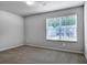 Bedroom with plush carpet, window overlooking neighborhood, and neutral color scheme at 921 Sundown Pt, Villa Rica, GA 30180