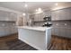 Open concept kitchen with gray cabinetry, stainless steel appliances, and a large island with seating at 921 Sundown Pt, Villa Rica, GA 30180