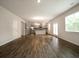 Bright and open living room that leads into the kitchen, with hardwood floors and neutral paint at 921 Sundown Pt, Villa Rica, GA 30180