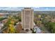 High-rise condo building with a pool and lush trees in the background at 1501 Clairmont Rd # 1731, Decatur, GA 30033