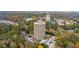Aerial view of the high-rise condo building showcasing the pool and lush trees at 1501 Clairmont Rd # 1731, Decatur, GA 30033