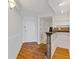 Welcoming hallway with hardwood floors, leading to a kitchenette, and a front door with white trim at 1501 Clairmont Rd # 1731, Decatur, GA 30033