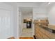 Hallway leading to a kitchen featuring shelving and brick accent wall at 1501 Clairmont Rd # 1731, Decatur, GA 30033