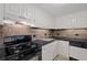 Kitchen featuring black countertops, tiled backsplash, white cabinets, oven, sink and dishwasher at 1501 Clairmont Rd # 1731, Decatur, GA 30033