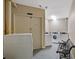 Clean and organized laundry room with multiple washers and dryers and a bench for your comfort at 1501 Clairmont Rd # 1731, Decatur, GA 30033