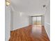 Spacious living room with hardwood floors and a sliding door to a balcony, shelving, and white trim at 1501 Clairmont Rd # 1731, Decatur, GA 30033