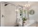 Modern bathroom with a glass enclosed shower, soaker tub and chandelier at 2238 Parkview Nw Ct, Atlanta, GA 30318
