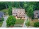 Stunning aerial view of a brick house with lush greenery and a well-maintained lawn at 2748 Hidden Falls Dr, Buford, GA 30519