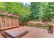 Relaxing back deck featuring a hot tub with a natural, wooded backdrop, perfect for outdoor leisure at 2748 Hidden Falls Dr, Buford, GA 30519