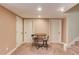 Finished basement area with seating, table, and three doors at 2748 Hidden Falls Dr, Buford, GA 30519