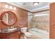 Bathroom featuring a stylish vanity, decorative mirror, tiled shower, and neutral flooring at 2748 Hidden Falls Dr, Buford, GA 30519