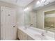 Bathroom boasts double sinks, a large mirror, and a door to the shower at 2748 Hidden Falls Dr, Buford, GA 30519