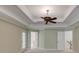 This bedroom offers neutral carpet, crown molding, tray ceiling, and a modern fan at 2748 Hidden Falls Dr, Buford, GA 30519