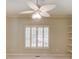 This bedroom features neutral paint, shuttered windows, and a modern ceiling fan with lighting at 2748 Hidden Falls Dr, Buford, GA 30519