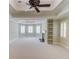 Spacious bedroom with neutral paint, coffered ceiling, fireplace, and built in shelving at 2748 Hidden Falls Dr, Buford, GA 30519