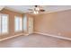 Bedroom with neutral paint, carpet flooring, ceiling fan, base trim, and plantation shutters at 2748 Hidden Falls Dr, Buford, GA 30519