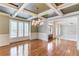 Elegant dining room featuring hardwood flooring, a stylish chandelier, and large windows at 2748 Hidden Falls Dr, Buford, GA 30519