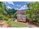Expansive rear house view with plentiful windows overlooking extensive green lawns at 2748 Hidden Falls Dr, Buford, GA 30519