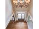 This foyer features hardwood floors, neutral paint, and a dark-stained front door with sidelights at 2748 Hidden Falls Dr, Buford, GA 30519